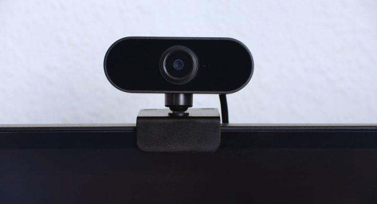 Webcam noire clipsee sur le bord superieur d'un moniteur
